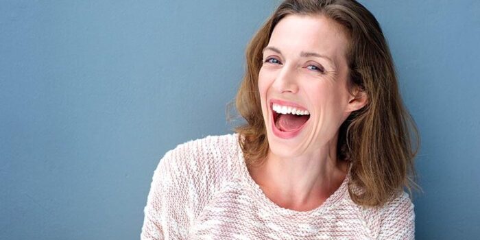 Happy beautiful fresh mid adult woman laughing